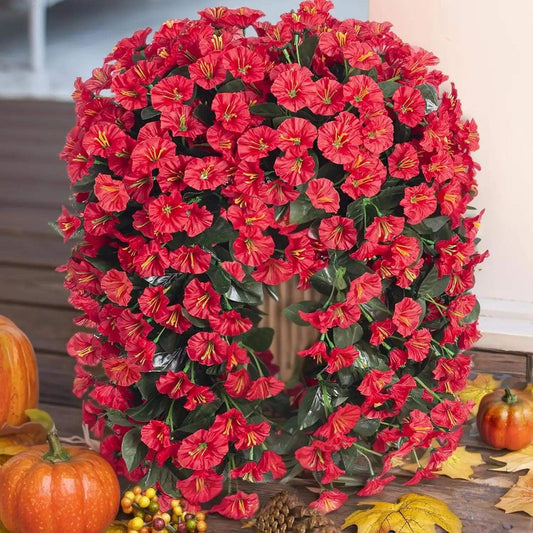 Vibrant artificial red flowers in a wreath, perfect for home decoration, autumn ambiance, or festive occasions.
