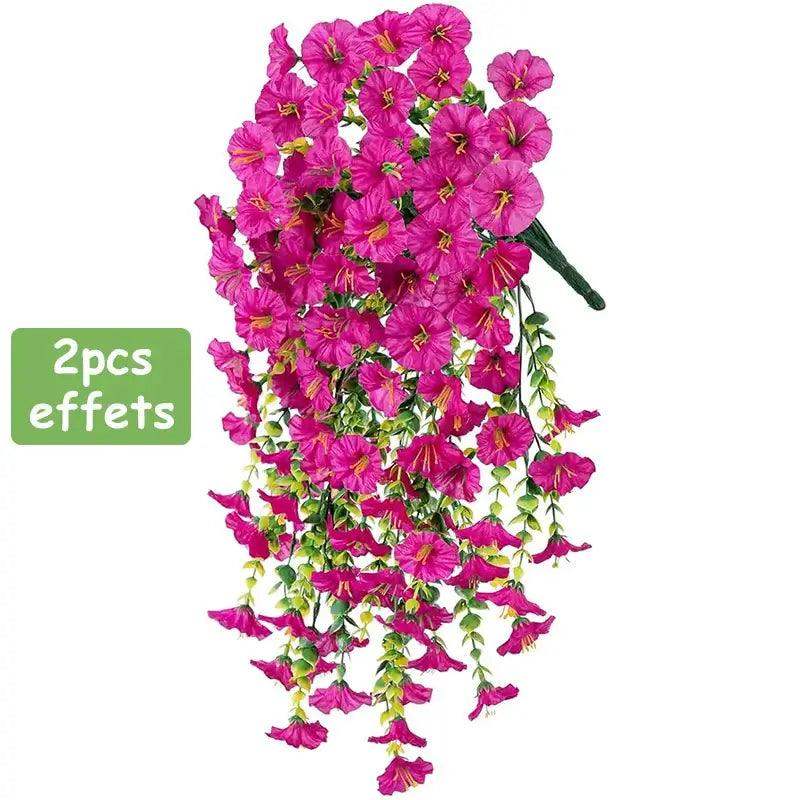 Vibrant pink artificial hanging flowers with long vines for home and garden decoration.